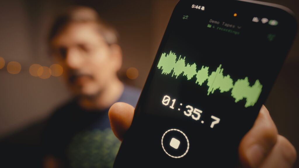 WasabiNoise holding an iPhone with the app Drop recording audio